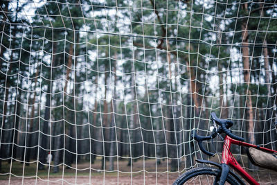 Close-up of bicycle by fence