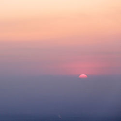 Scenic view of sea against romantic sky at sunset