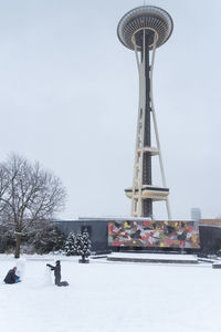 Traditional windmill on field against sky during winter