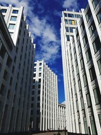 Low angle view of modern buildings in city against sky