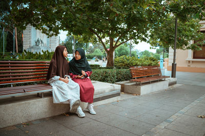 Portrait of young woman sitting in park