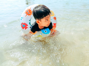 Cute boy swimming in pool