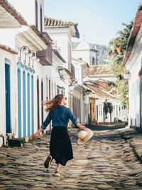 Side view of young woman walking on street