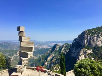 Scenic view of mountains against clear blue sky