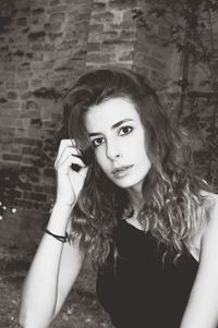 Portrait of girl against brick wall