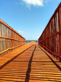 Surface level of footbridge on footpath against sky