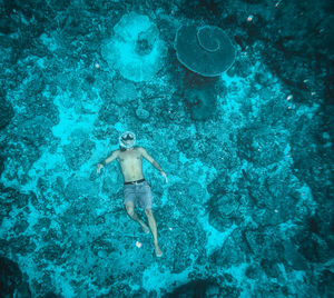 High angle view of child swimming in sea