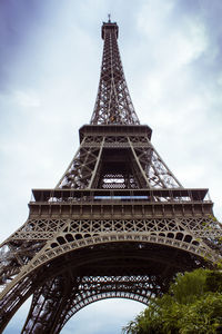 Low angle view of eiffel tower against cloudy sky