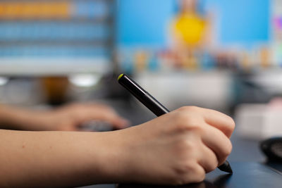 Close-up of hand holding mobile phone