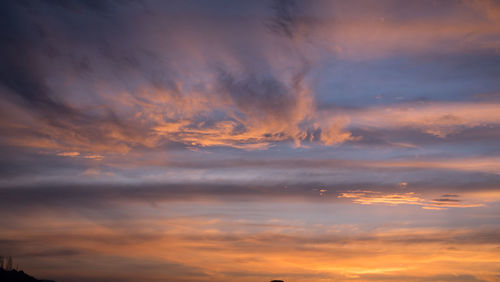 Low angle view of dramatic sky during sunset