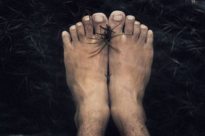 Close-up of human hand against black background