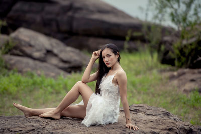 Woman sitting on rock