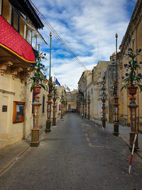 Empty alley amidst buildings in city