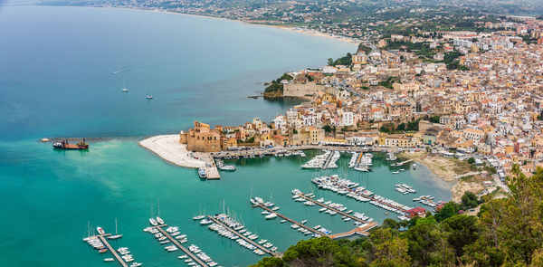 High angle view of buildings by sea