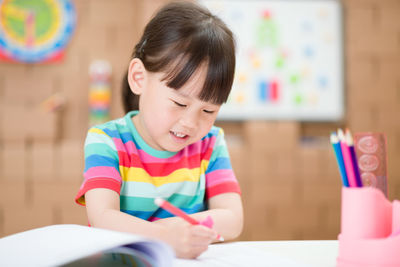 Cute girl sitting on table