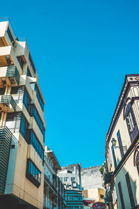 Low angle view of buildings against blue sky