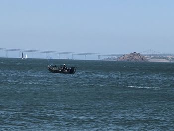 View of bridge over sea against clear sky