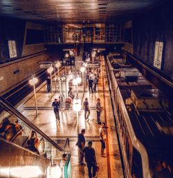 High angle view of people walking in illuminated city