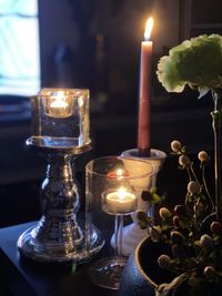 Close-up of illuminated tea light candles on table