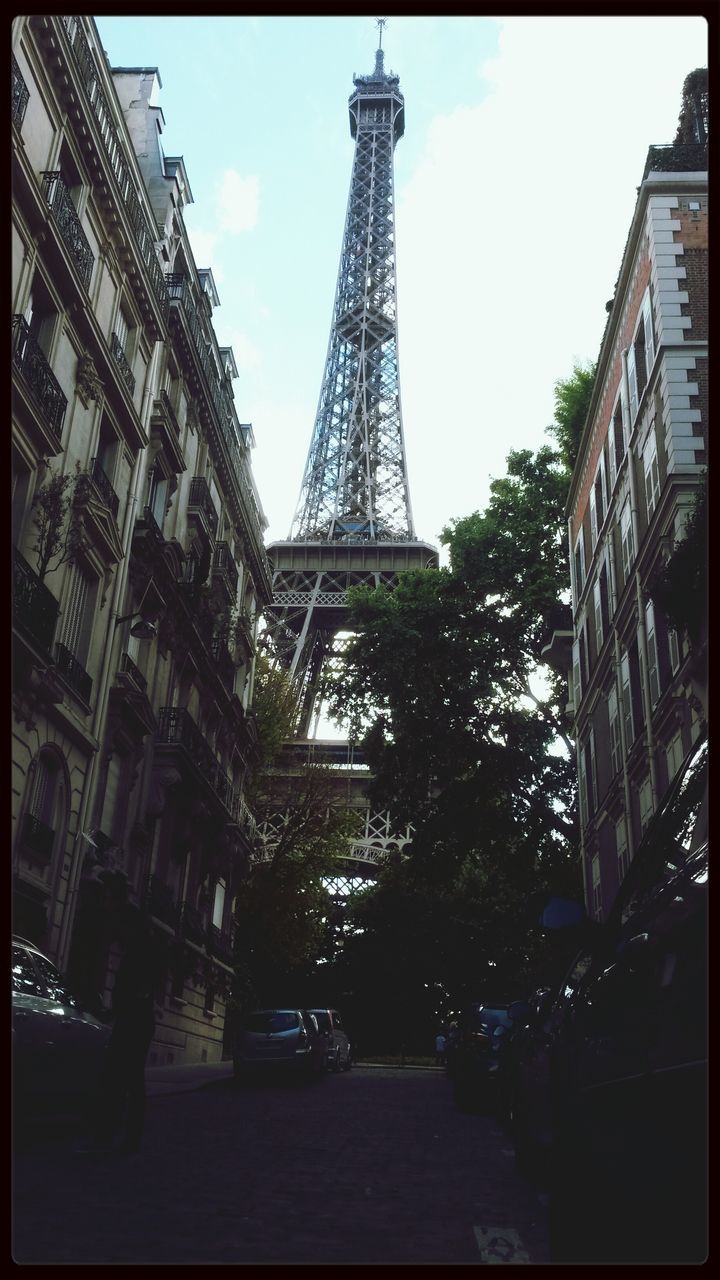 architecture, built structure, building exterior, transfer print, tower, city, tall - high, low angle view, sky, auto post production filter, famous place, eiffel tower, travel destinations, capital cities, international landmark, skyscraper, culture, day, tall, travel