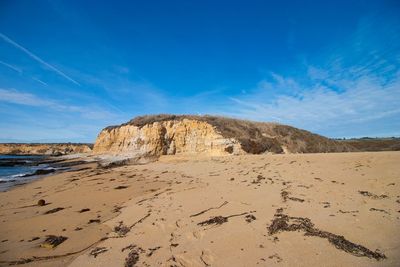 Scenic view of beach against blue sky