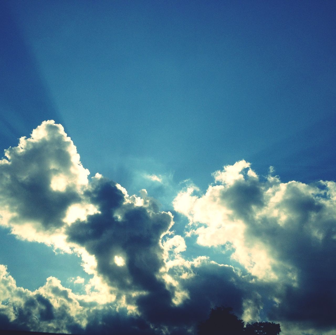 low angle view, blue, sky, beauty in nature, cloud - sky, sky only, scenics, tranquility, nature, tranquil scene, cloudscape, cloud, sunbeam, sunlight, idyllic, majestic, outdoors, cloudy, day, no people