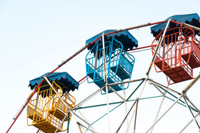 Low angle view of ferris wheel against clear sky