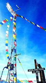 Low angle view of ferris wheel against blue sky