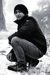 Portrait of young woman sitting in winter