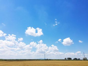 Scenic view of field against blue sky