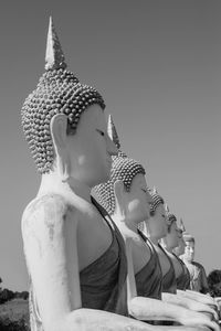 Statue of buddha against building