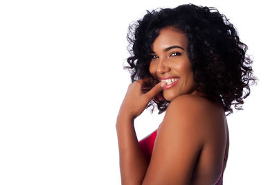 Portrait of young woman against white background