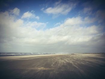 Scenic view of sea against cloudy sky