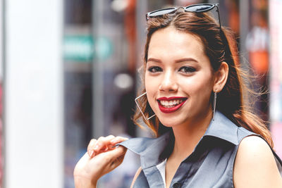 Close-up portrait of happy young woman in city