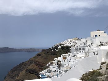 High angle view of buildings against cloudy sky