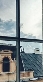 Building against sky seen through glass window