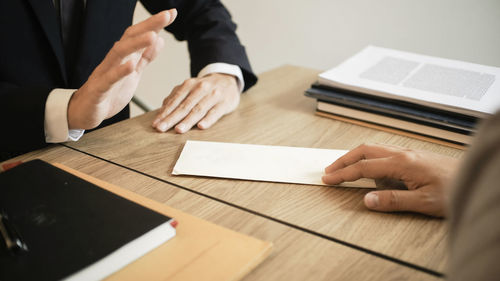 Low section of man working on table