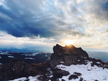 Scenic view of snowcapped mountains against sky during sunset