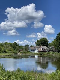 Scenic view of lake by building against sky