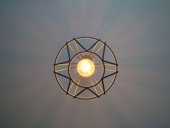 Directly below shot of illuminated pendant light hanging from ceiling