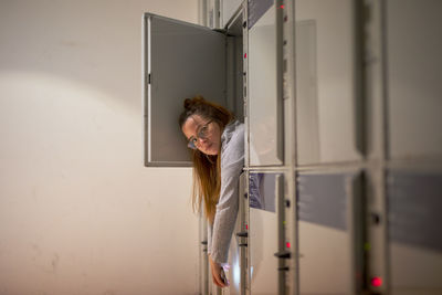 Portrait of young woman relaxing in locker