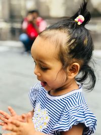 Close-up of cute girl playing outdoors