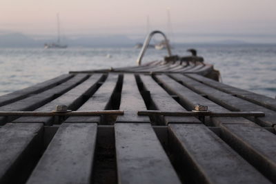 Pier over sea against sky during sunset 