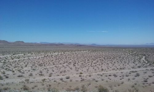 Scenic view of landscape against clear blue sky