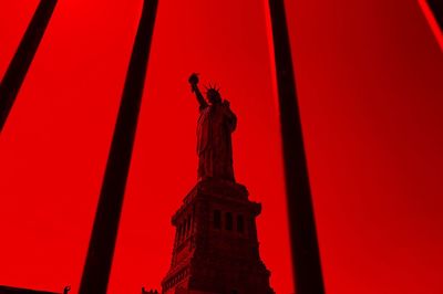 Low angle view of statue against red temple