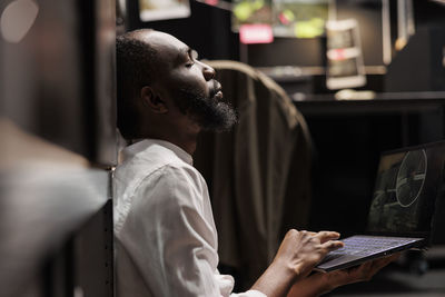 Side view of man using mobile phone