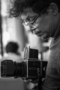 Close-up of man photographing with camera