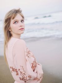 Beautiful woman standing at beach
