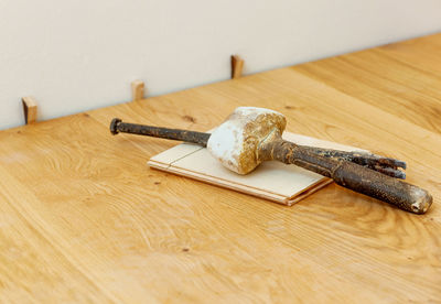High angle view of hammer on wooden table