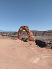 Built structure on desert against clear blue sky